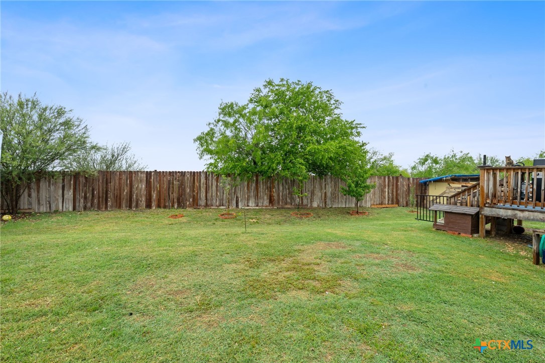 121 Fate Court Kyle, TX 78640 - Photo 21 of 23 a backyard of a house with table and chairs