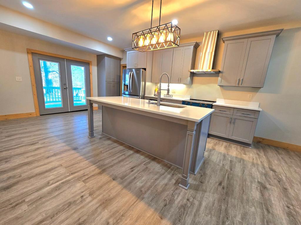 2417 Mobile Road McCaysville, GA 30555 - Photo 5 of 17 a kitchen with stainless steel appliances granite countertop a sink stove and wooden floor