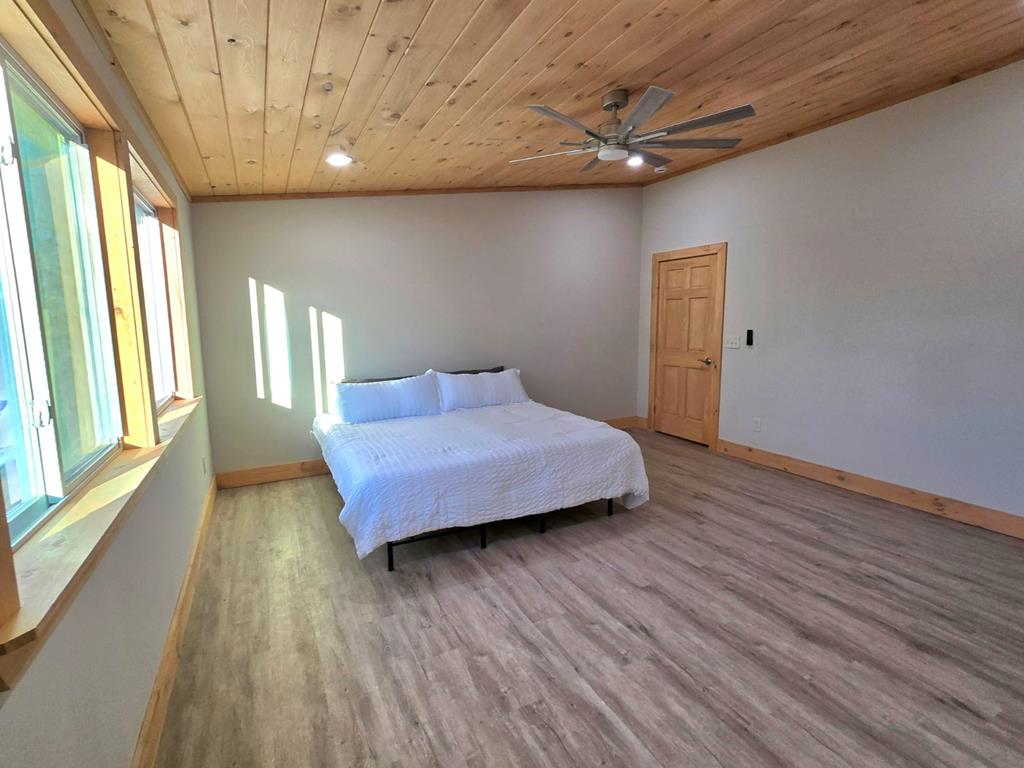 2417 Mobile Road McCaysville, GA 30555 - Photo 7 of 17 a bedroom with a bed and wooden floor