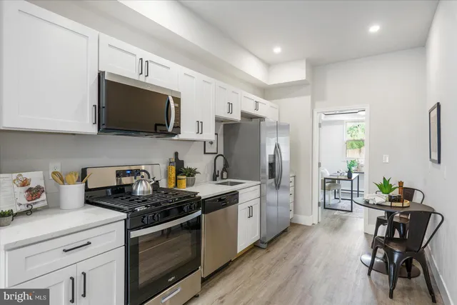 a kitchen with sink cabinets and stainless steel appliances