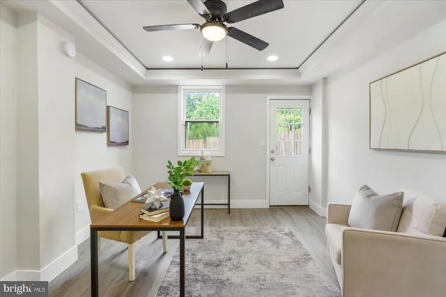 a view of a workspace with furniture and wooden floor