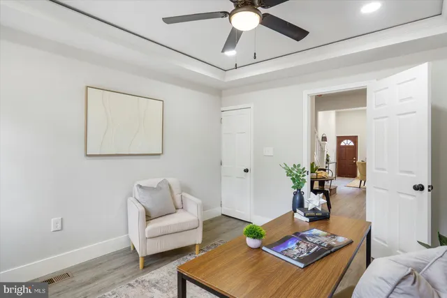 a living room with furniture a rug and a mirror