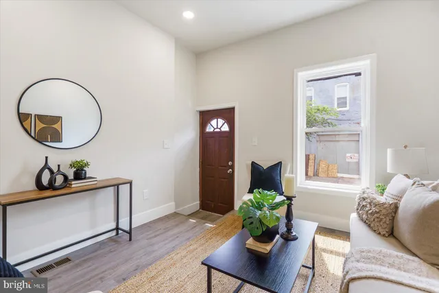 a living room with furniture and wooden floor