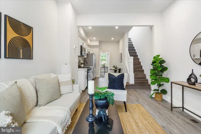a living room with furniture and a mirror