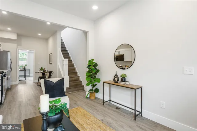 a living room with furniture and a potted plant