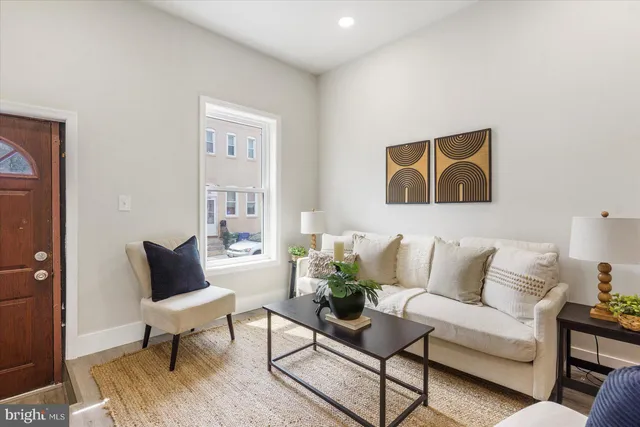 a kitchen with granite countertop a refrigerator a stove top oven a sink dishwasher and wooden floor