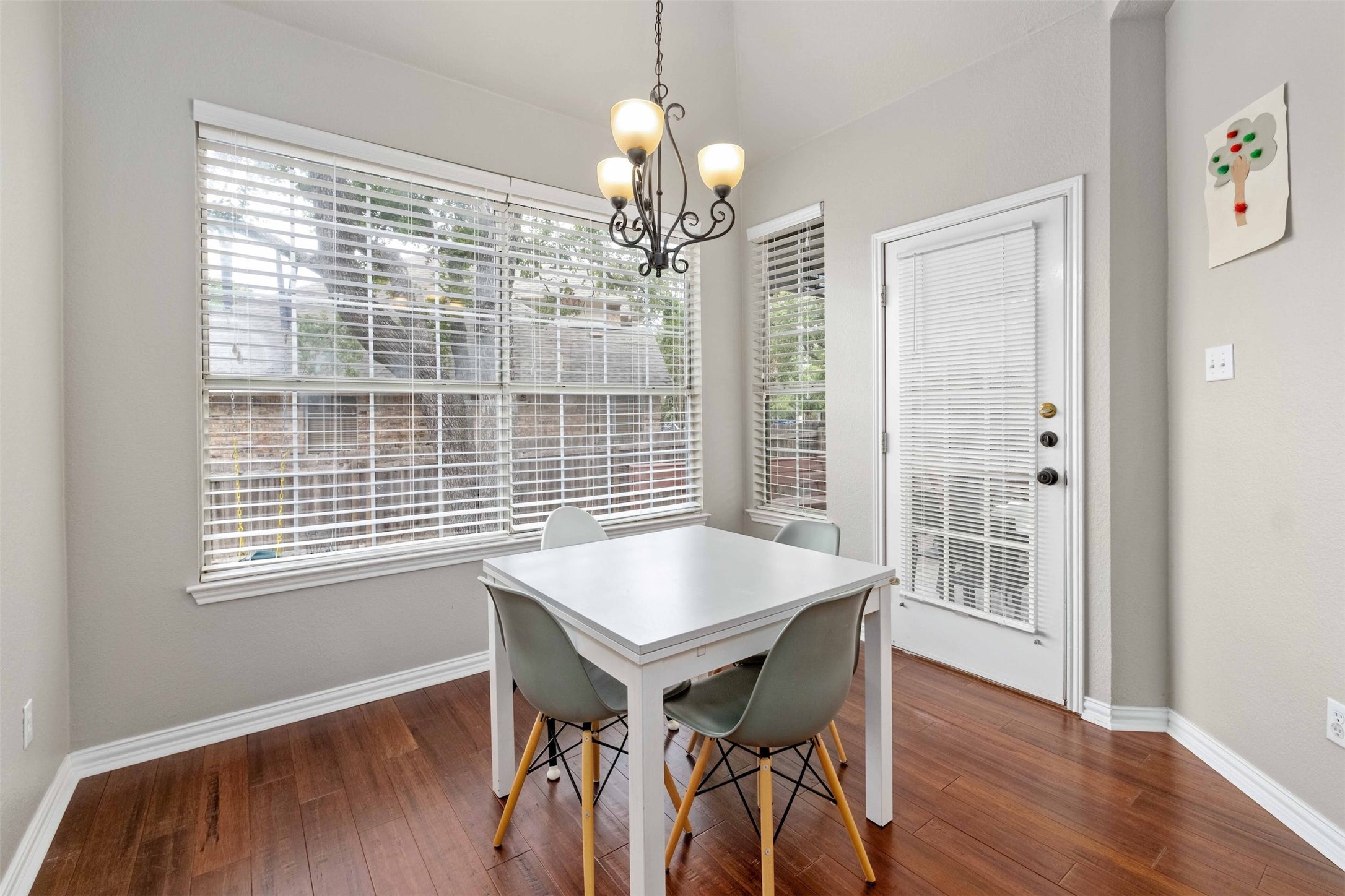 3704 Runnels Court Austin, TX 78732 - Photo 12 of 30 Dining space with a chandelier, baseboards, and a wealth of natural light