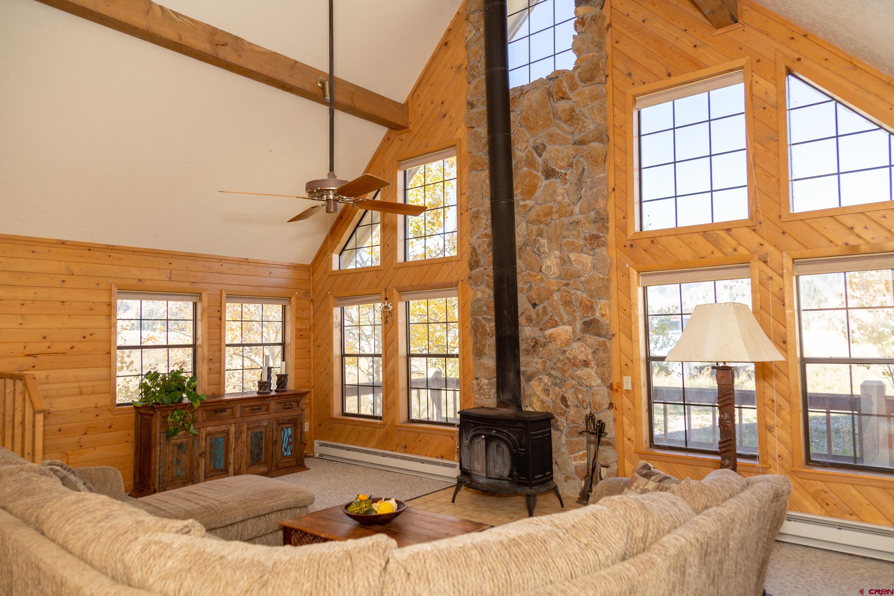 516 Rio Grande Court Creede, CO 81130 - Photo 12 of 33 a living room with furniture and a floor to ceiling windows