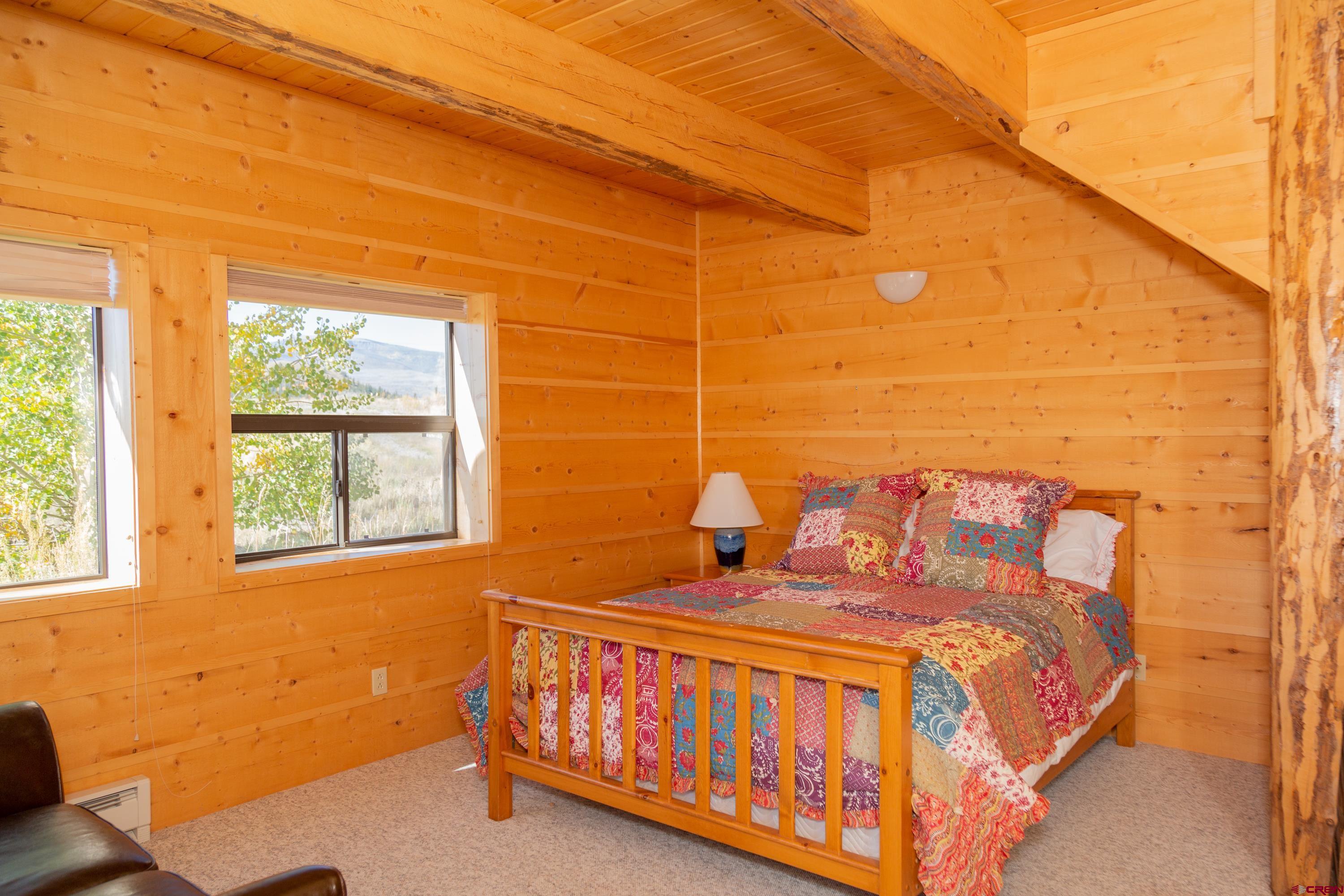 516 Rio Grande Court Creede, CO 81130 - Photo 17 of 33 a bed sitting in a bedroom next to a window