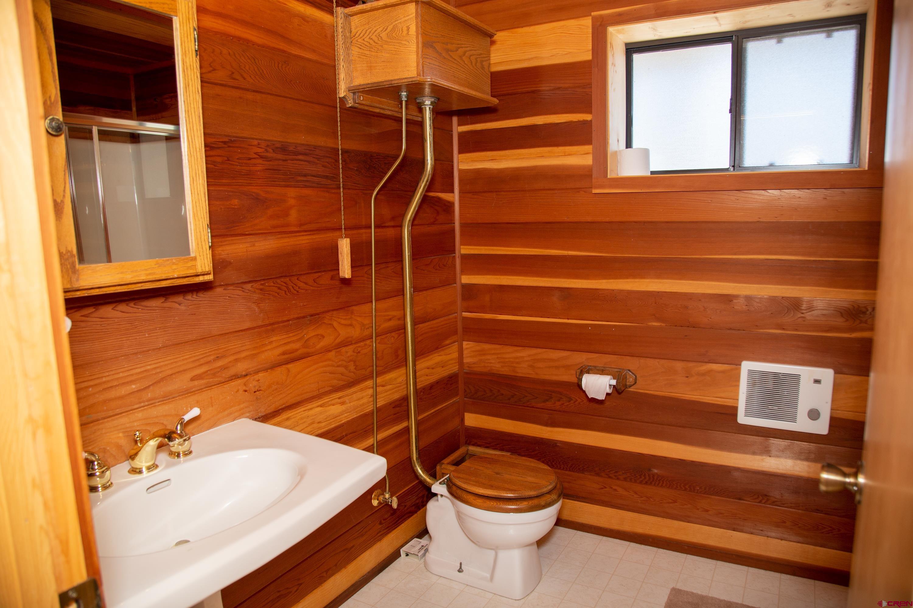516 Rio Grande Court Creede, CO 81130 - Photo 18 of 33 a bathroom with a sink mirror vanity and toilet