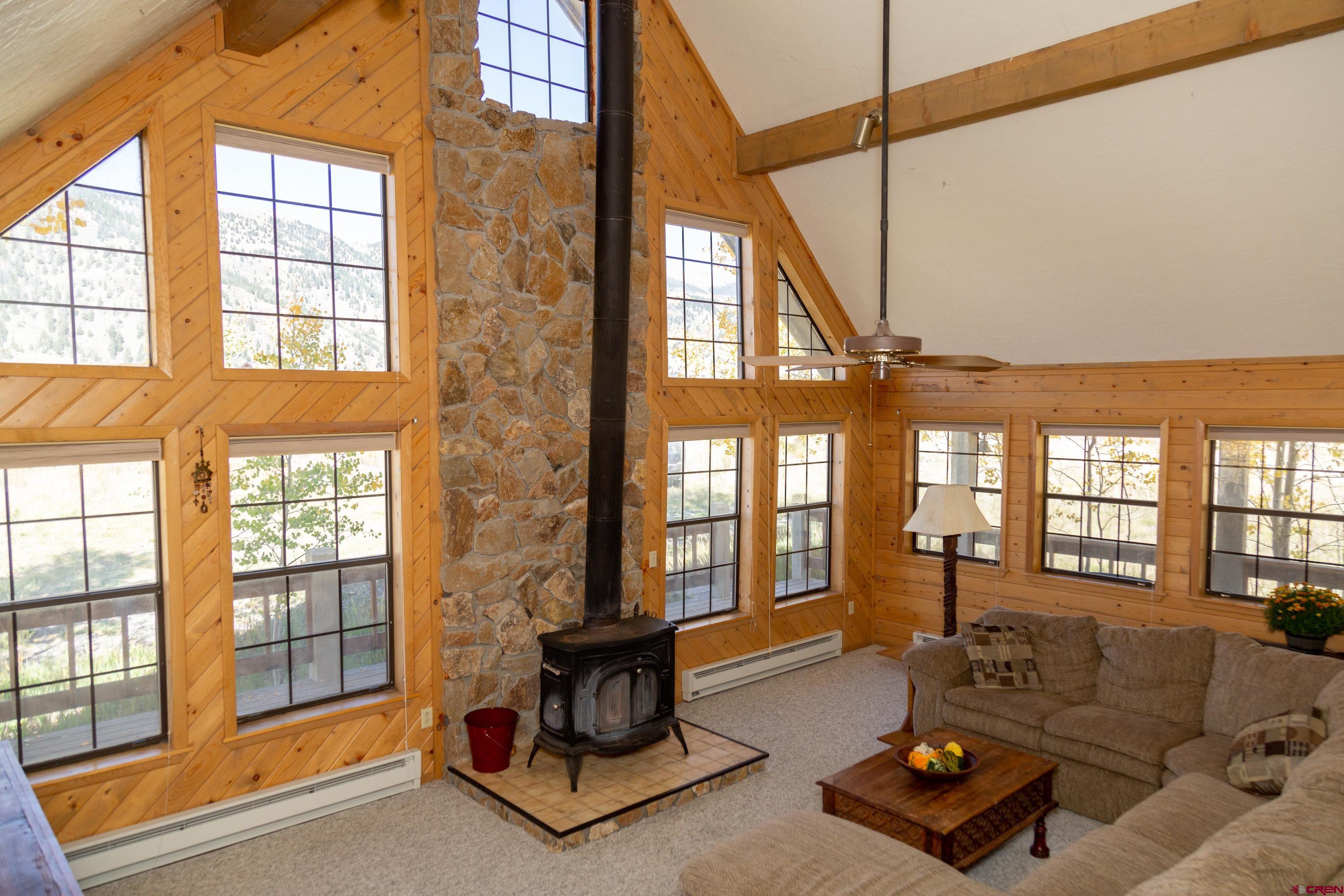 516 Rio Grande Court Creede, CO 81130 - Photo 21 of 33 a living room with furniture and a floor to ceiling window