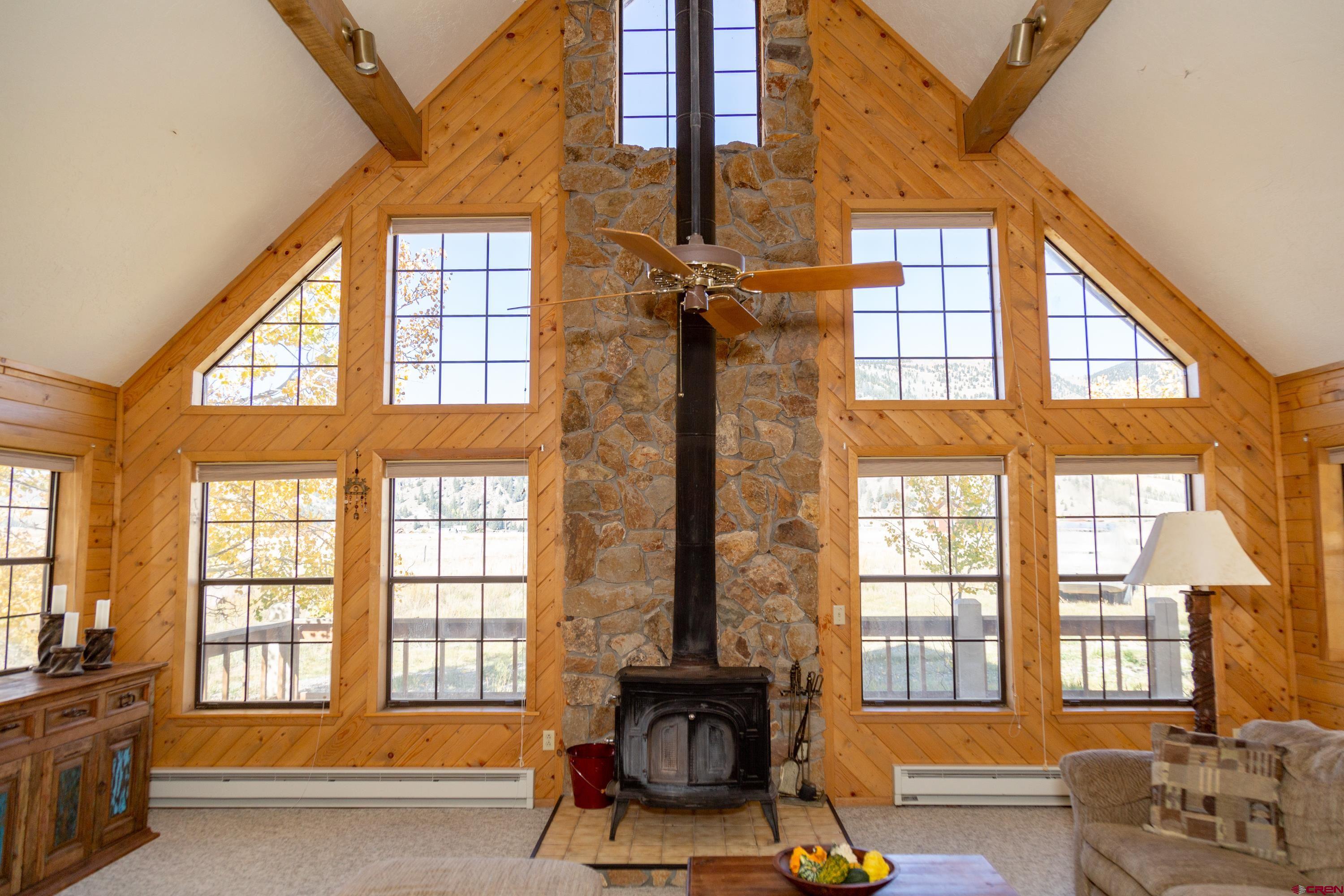 516 Rio Grande Court Creede, CO 81130 - Photo 3 of 33 a living room with furniture and floor to ceiling windows