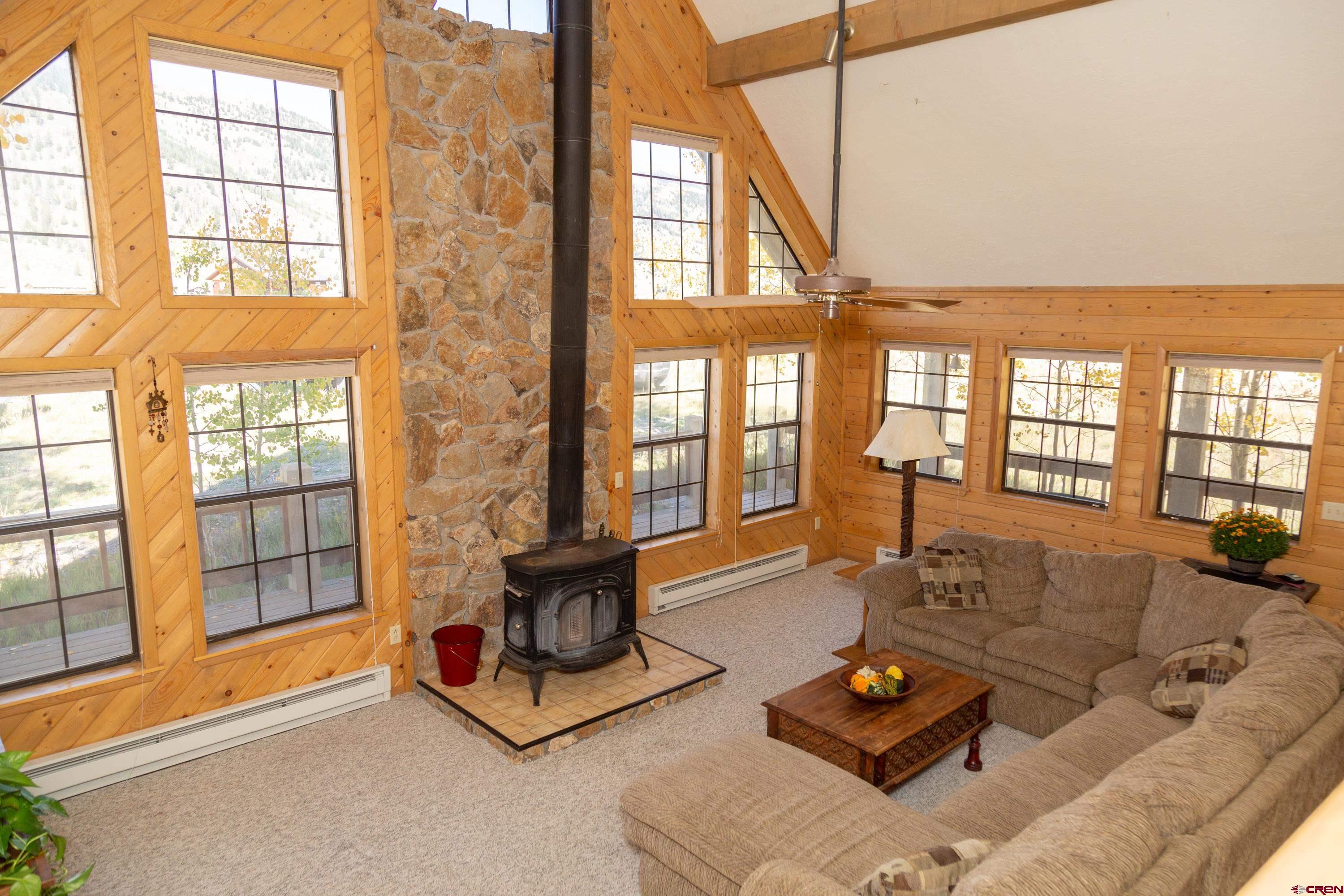516 Rio Grande Court Creede, CO 81130 - Photo 4 of 33 a living room with furniture and floor to ceiling windows