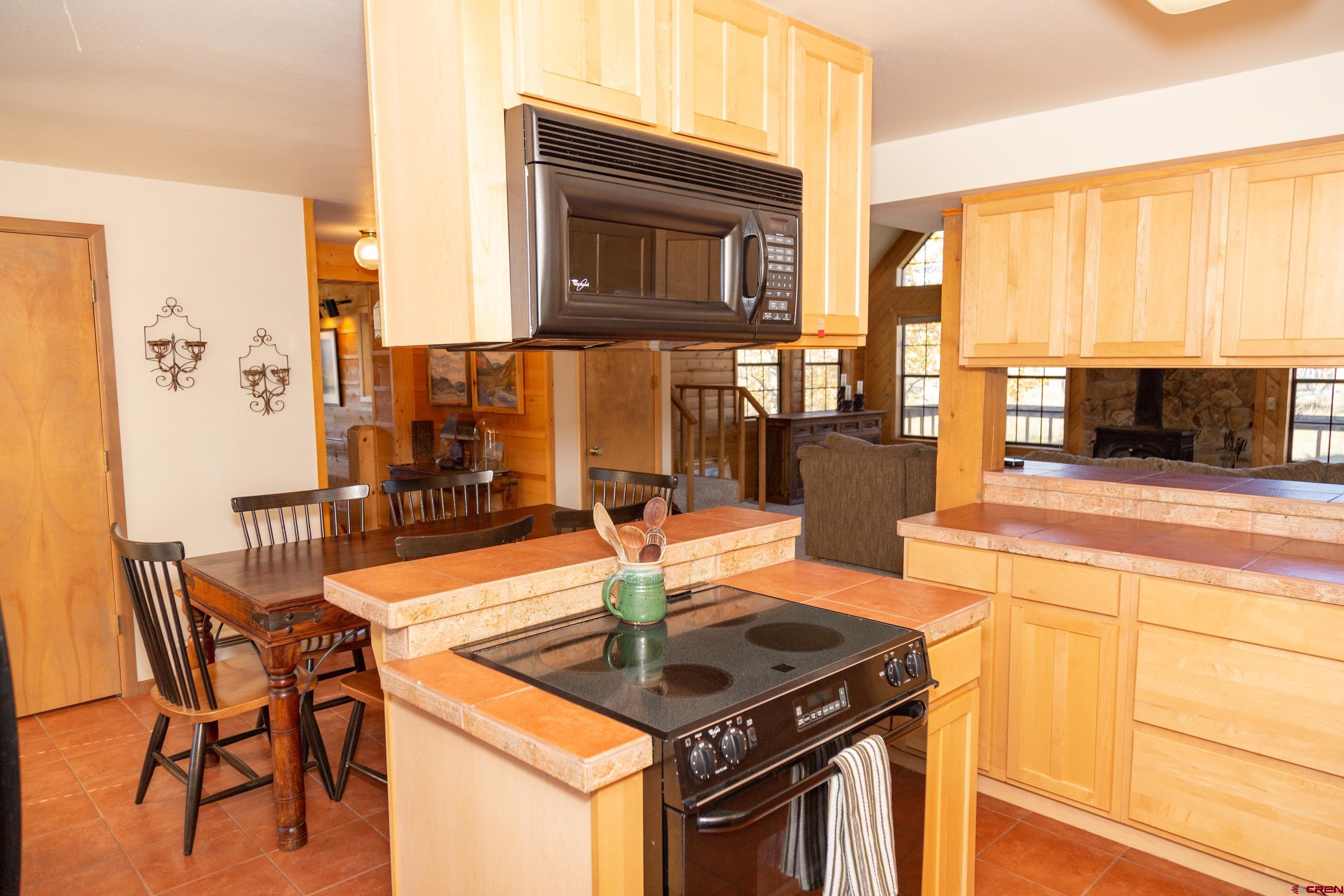 516 Rio Grande Court Creede, CO 81130 - Photo 5 of 33 a kitchen with stainless steel appliances granite countertop a stove a sink and a microwave