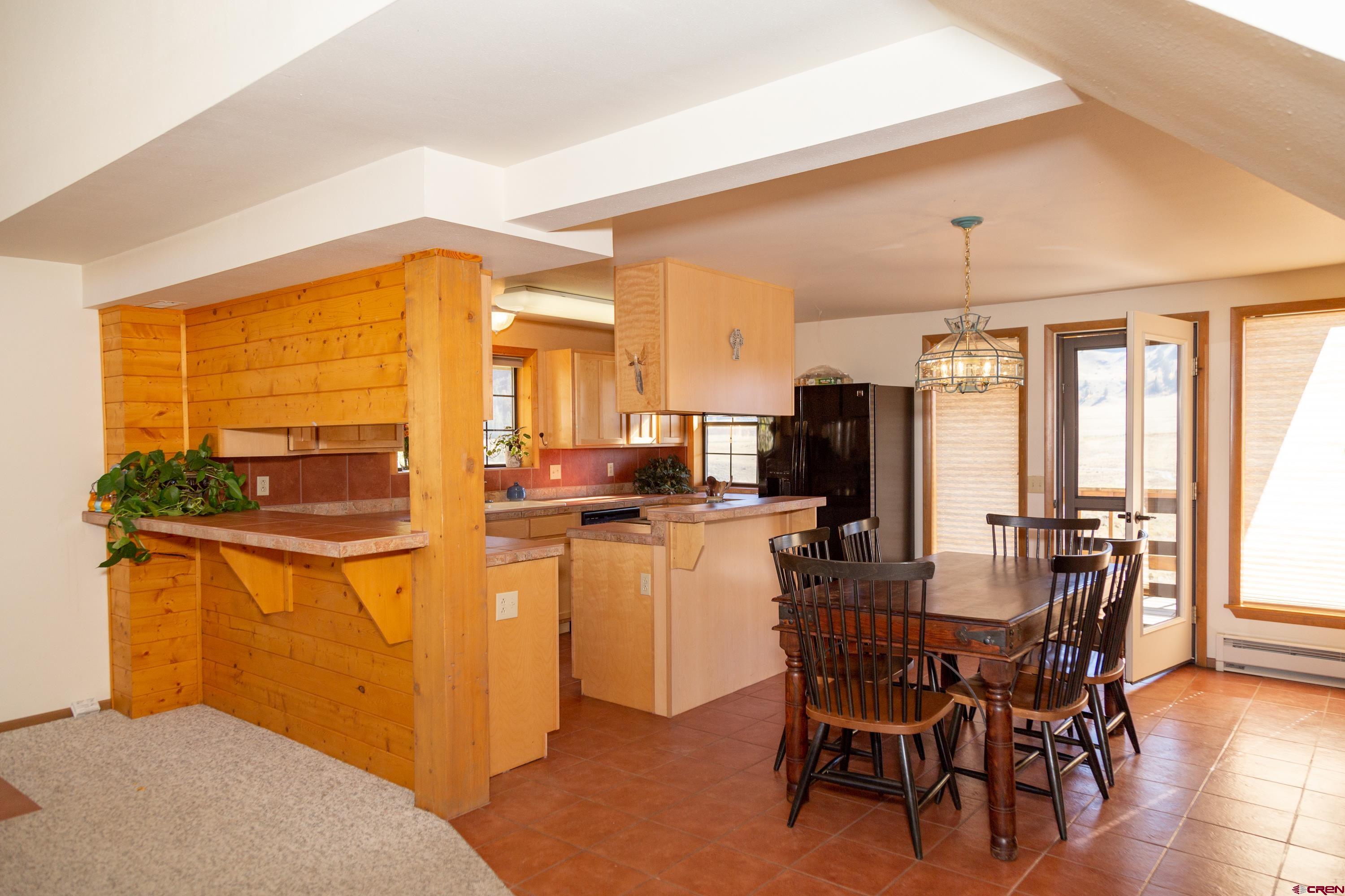 516 Rio Grande Court Creede, CO 81130 - Photo 8 of 33 a dining room with stainless steel appliances a table and chairs
