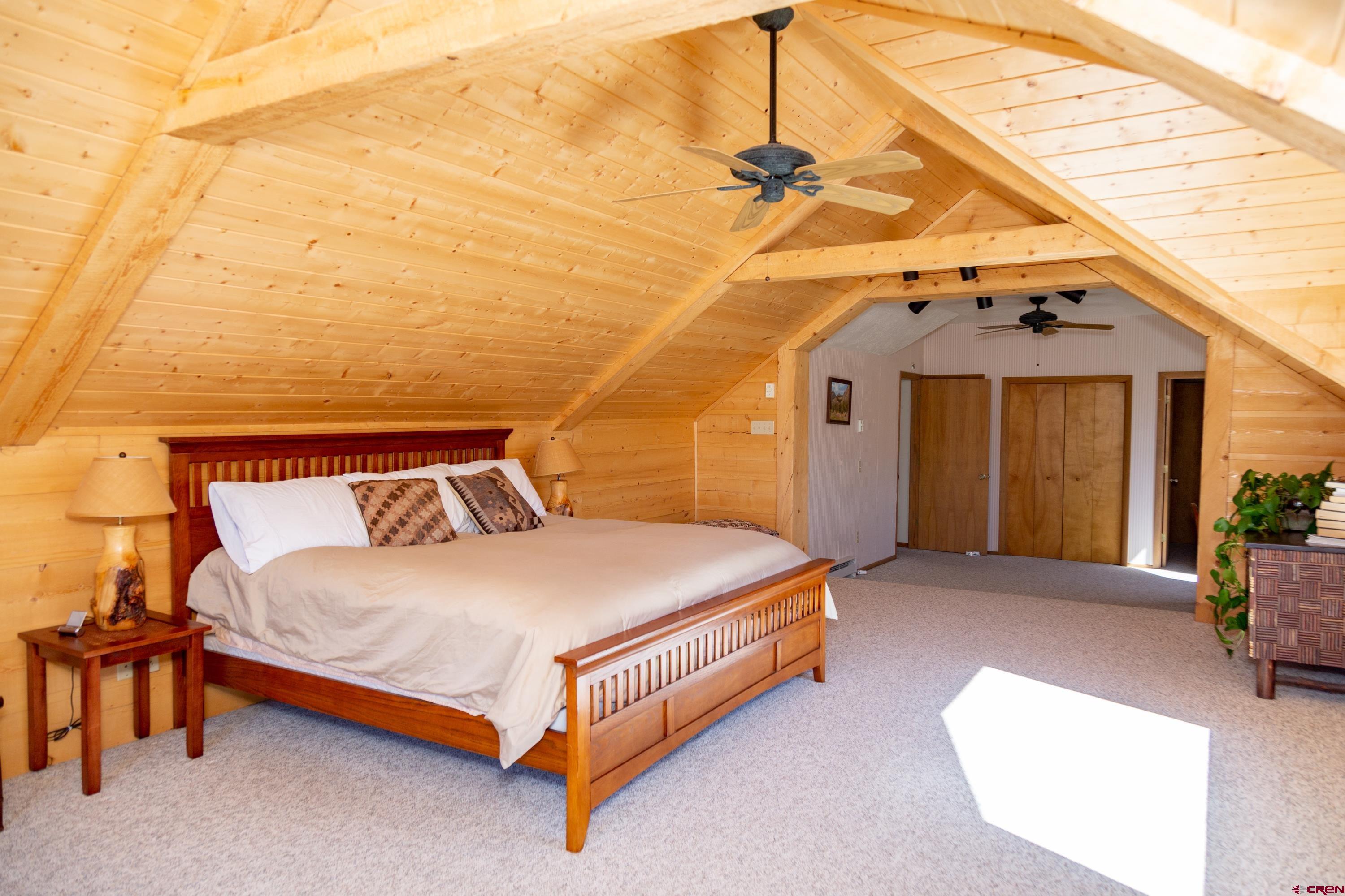 516 Rio Grande Court Creede, CO 81130 - Photo 9 of 33 a bed sitting in a spacious bedroom next to a window