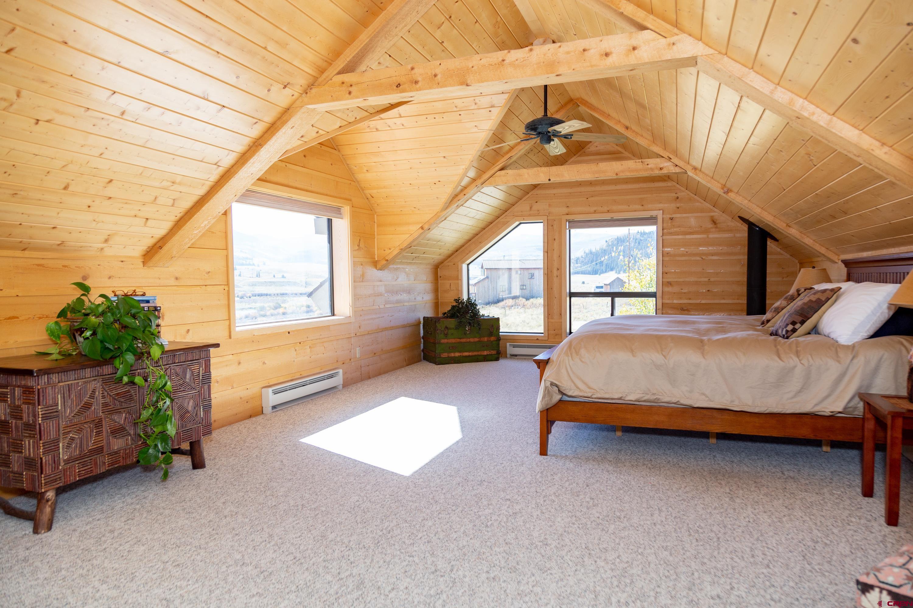 516 Rio Grande Court Creede, CO 81130 - Photo 10 of 33 a bedroom with a bed and a chandelier