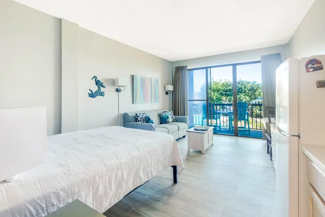 a bedroom with a bed and a large window