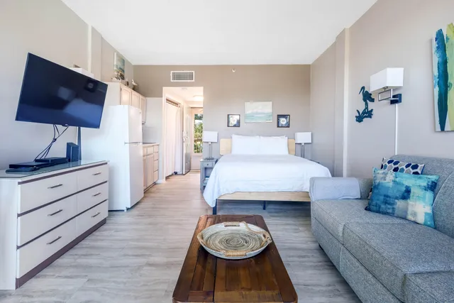 a bedroom with a bed and flat screen tv