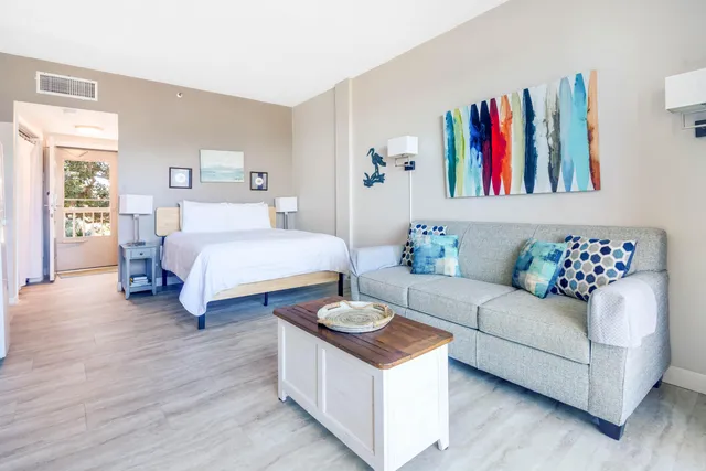 a spacious bedroom with a bed a couch and dresser