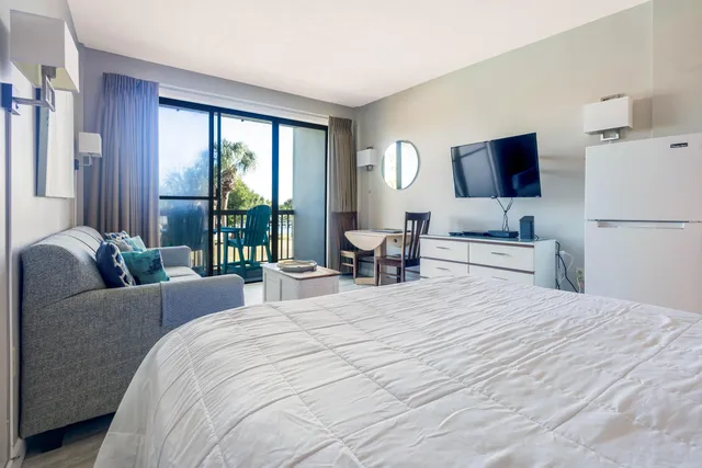 a bedroom with a large bed and a flat screen tv