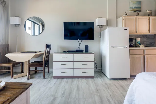 a kitchen with a wooden floor and a refrigerator