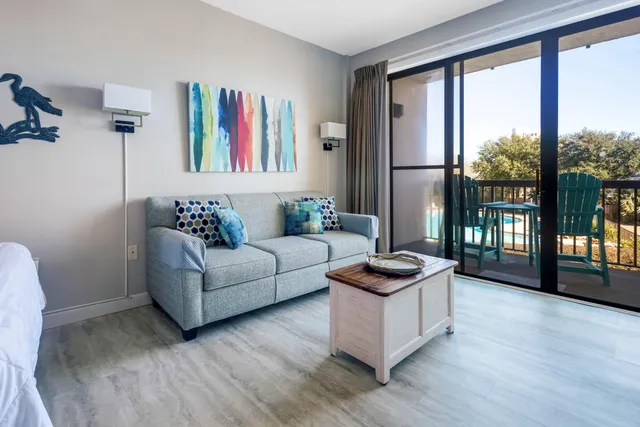 a living room with furniture and a floor to ceiling window