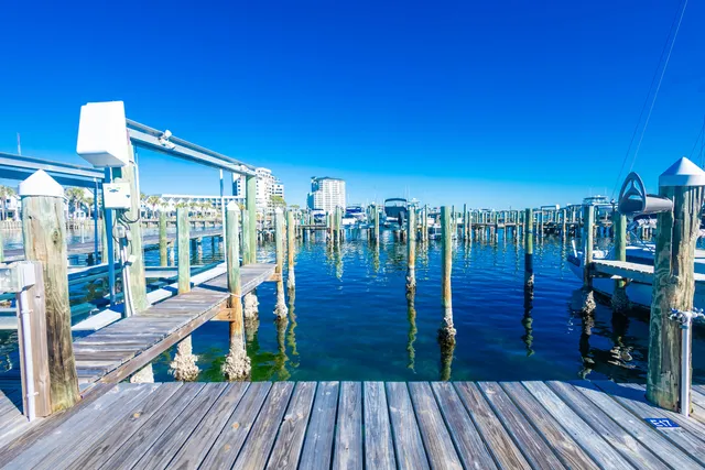 a view of a deck with dining table and chairs with wooden floor and fence