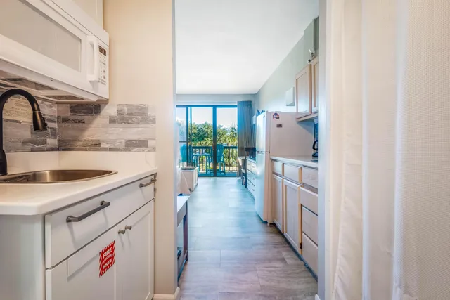 a kitchen with a sink stove and refrigerator