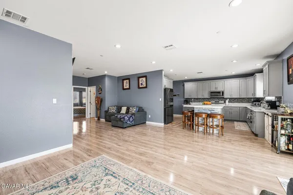 a kitchen with stainless steel appliances a sink a stove a microwave and cabinets