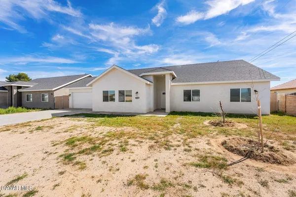 a view of a patio with a table and chairs
