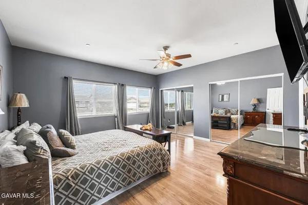 a bedroom with a large bed and a window
