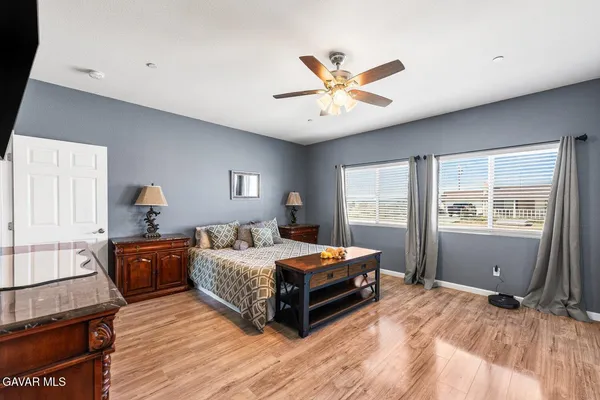a bedroom with a bed and a mirror