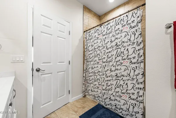 a bedroom with a bed and a desk