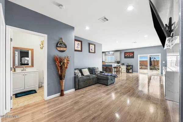 a living room with furniture a flat screen tv and a fireplace