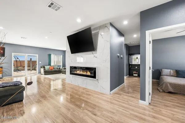 a living room with furniture fireplace and flat screen tv