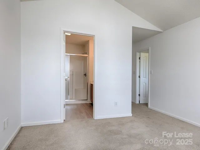 an empty room with closet and a bathroom