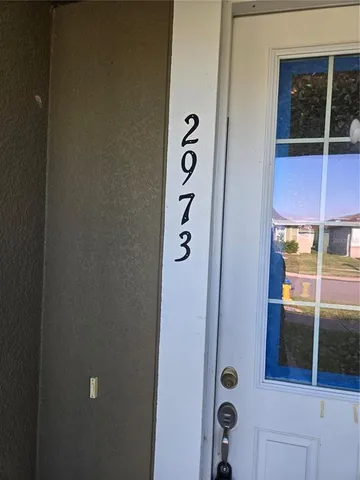 a kitchen with refrigerator and cabinets