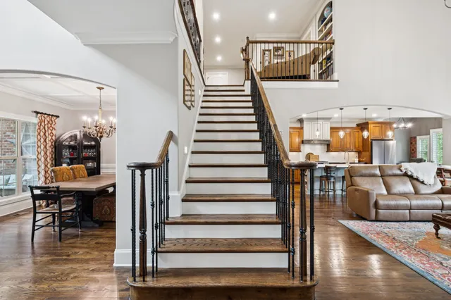 a kitchen with stainless steel appliances a dining table chairs and granite counter tops