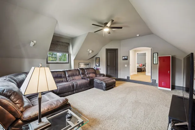 a dining hall with stainless steel appliances kitchen island a table and chairs