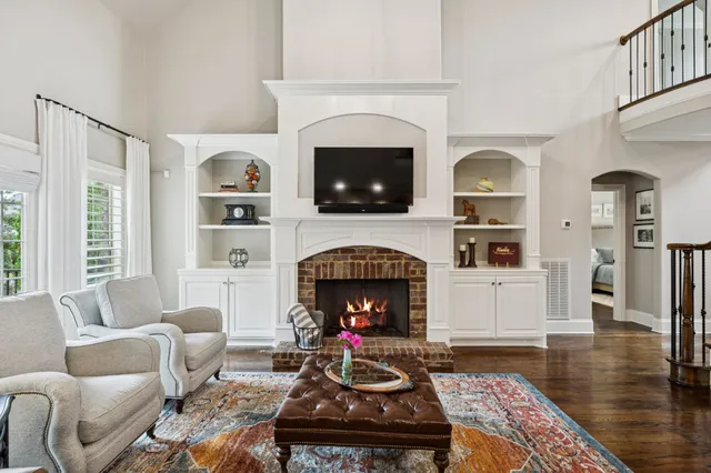 a kitchen with stainless steel appliances granite countertop a stove a refrigerator a kitchen island a dining table and chairs