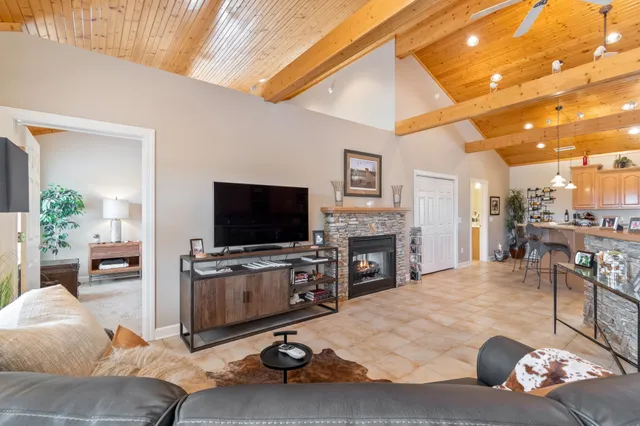 a storage room with water heater and racks on the kitchen