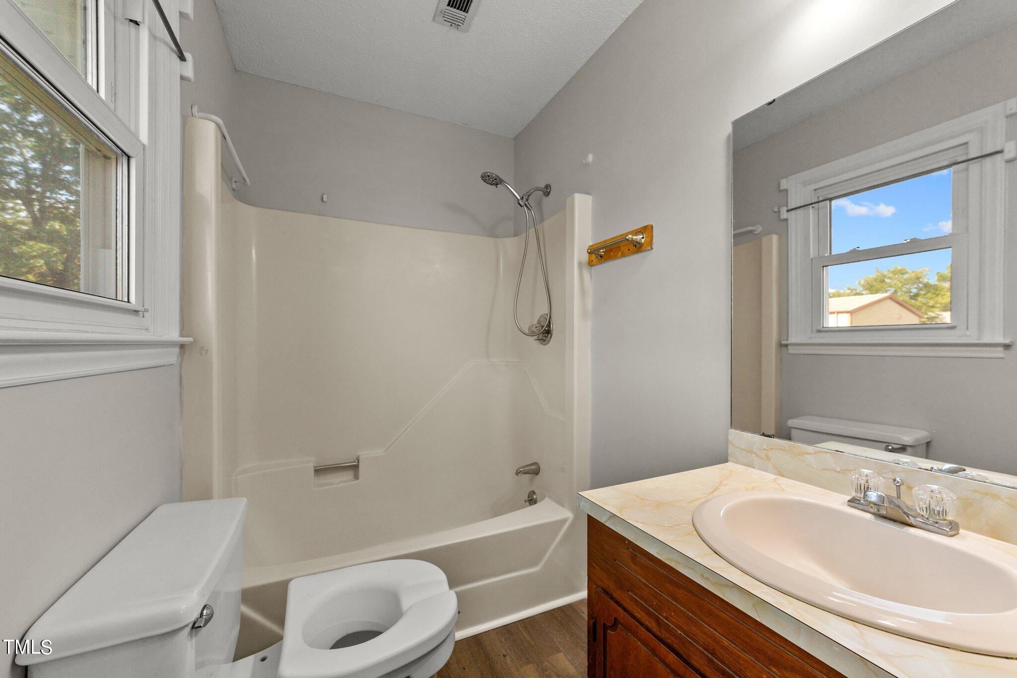 4868 Buffalo Road Selma, NC 27576 - Photo 22 of 48 a bathroom with a sink toilet and shower