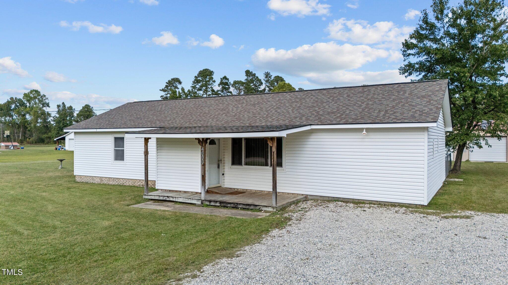 4868 Buffalo Road Selma, NC 27576 - Photo 29 of 48 a view of a house with a backyard