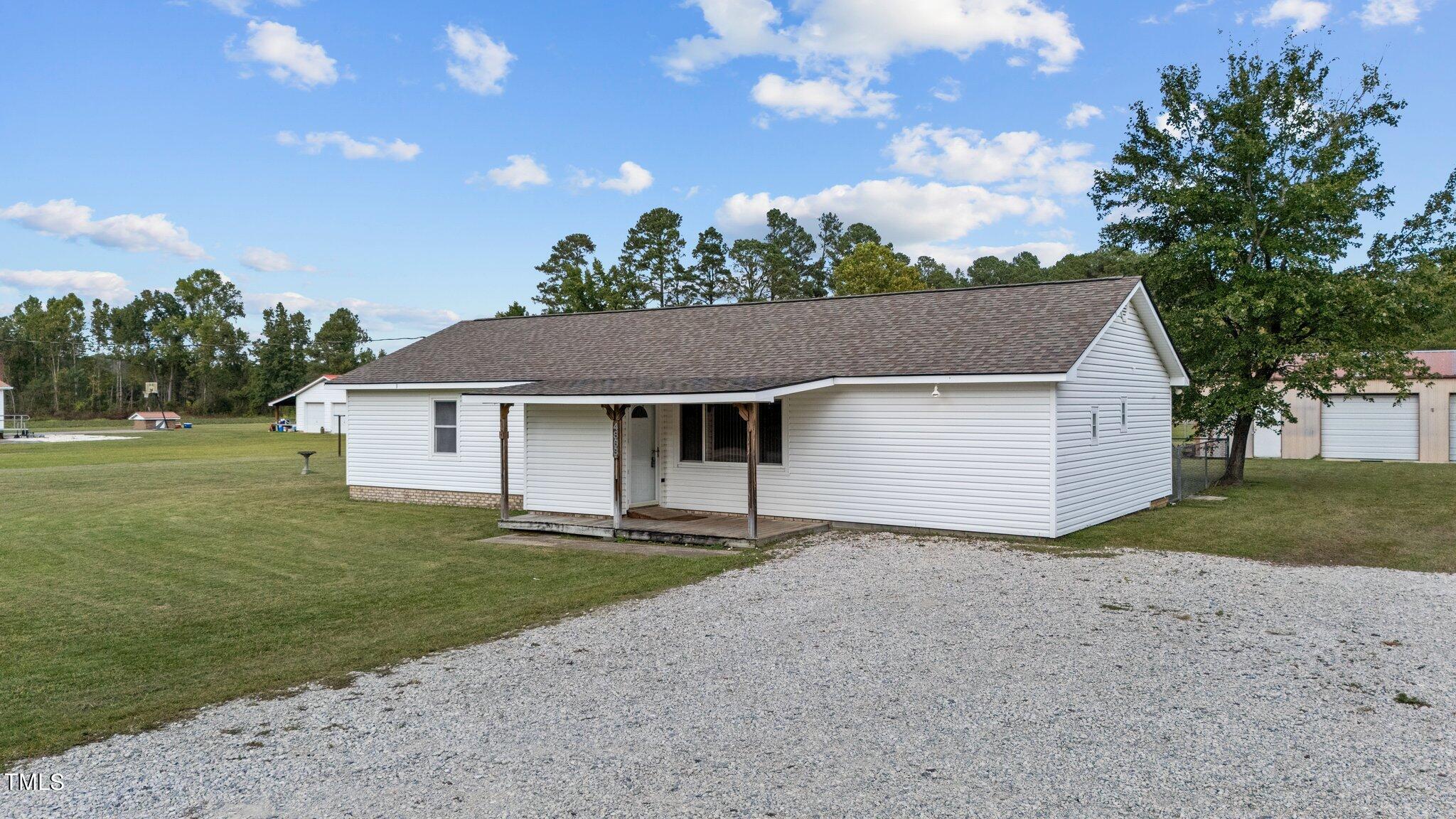 4868 Buffalo Road Selma, NC 27576 - Photo 35 of 48 a front view of a house with a garden and yard