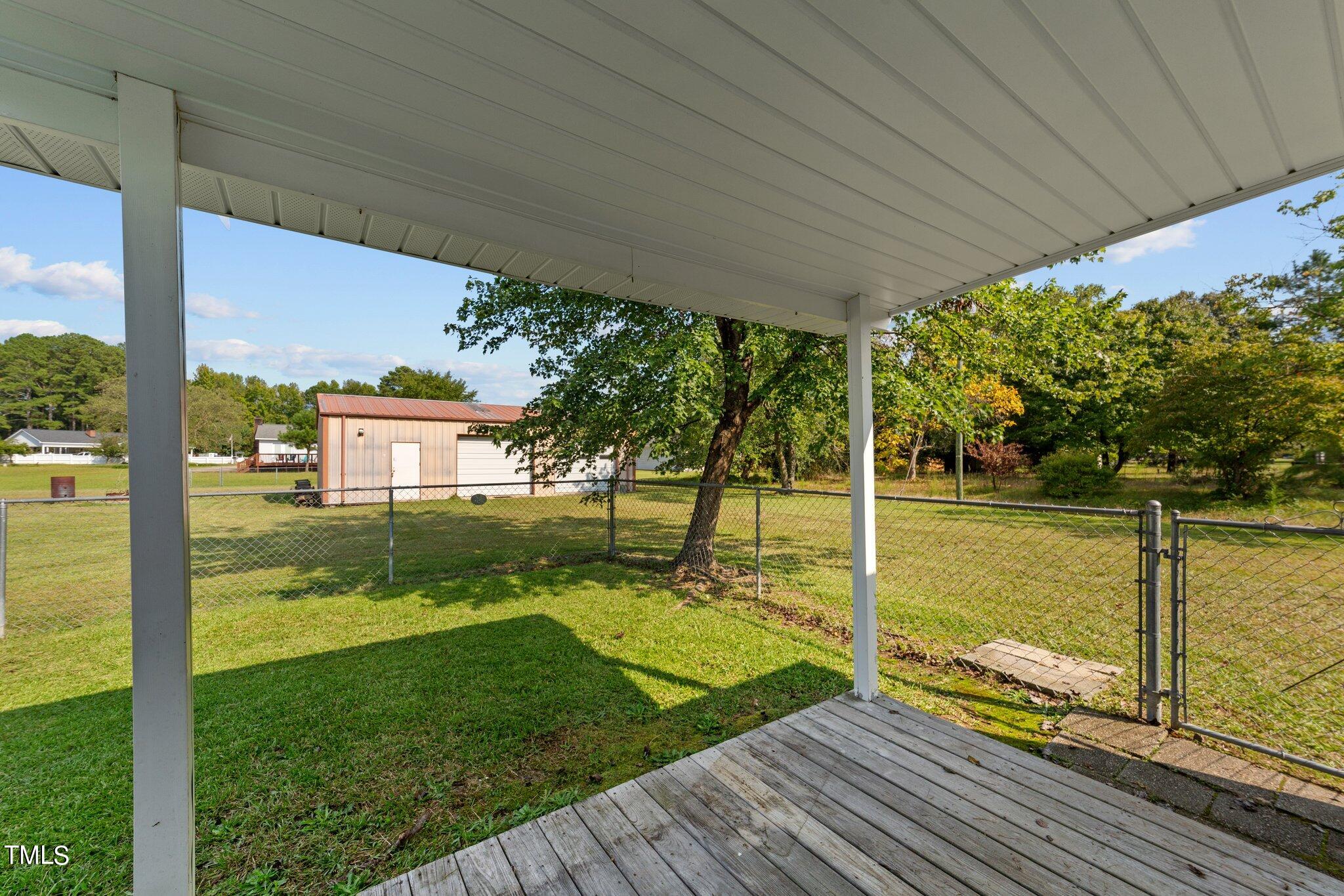 4868 Buffalo Road Selma, NC 27576 - Photo 42 of 48 a view of a deck with a big yard