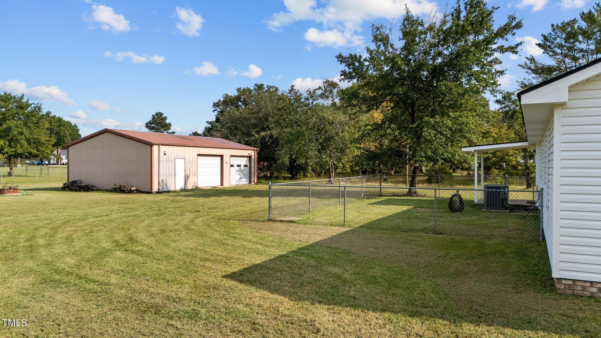 4868 Buffalo Road Selma, NC 27576 - Photo 45 of 48 a swimming pool with outdoor seating and yard