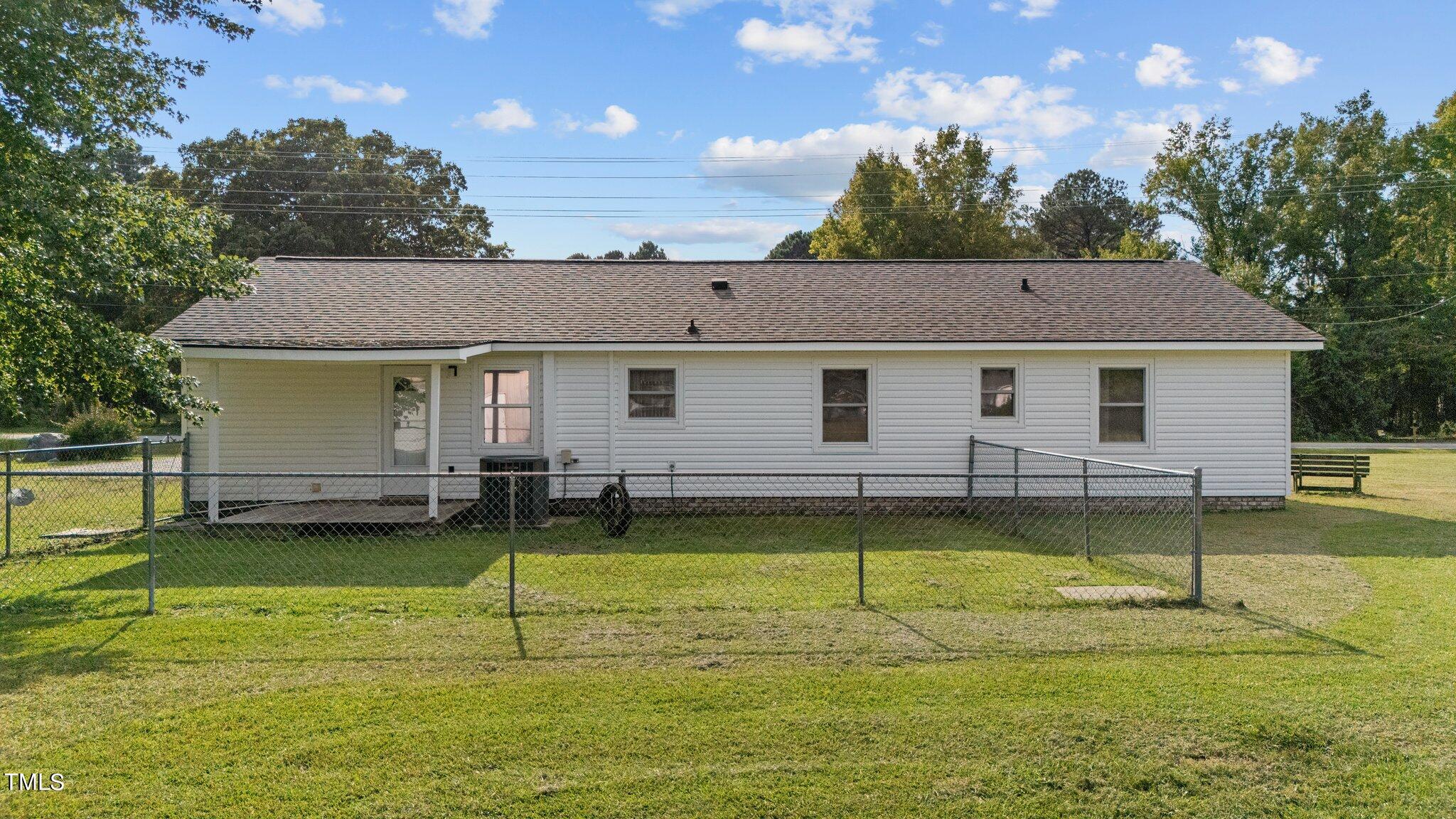 4868 Buffalo Road Selma, NC 27576 - Photo 46 of 48 a view of a house with swimming pool and a yard