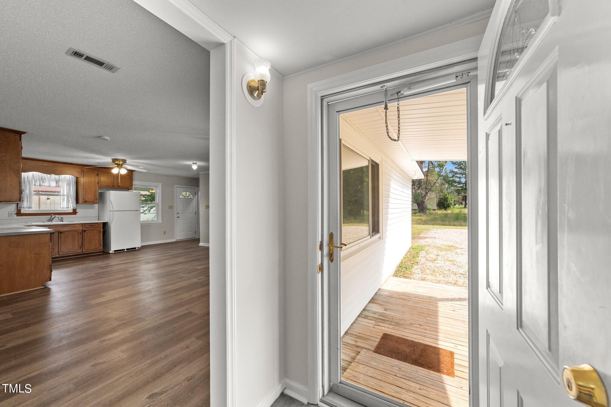 4868 Buffalo Road Selma, NC 27576 - Photo 5 of 48 a view of a hallway view with wooden floor and windows
