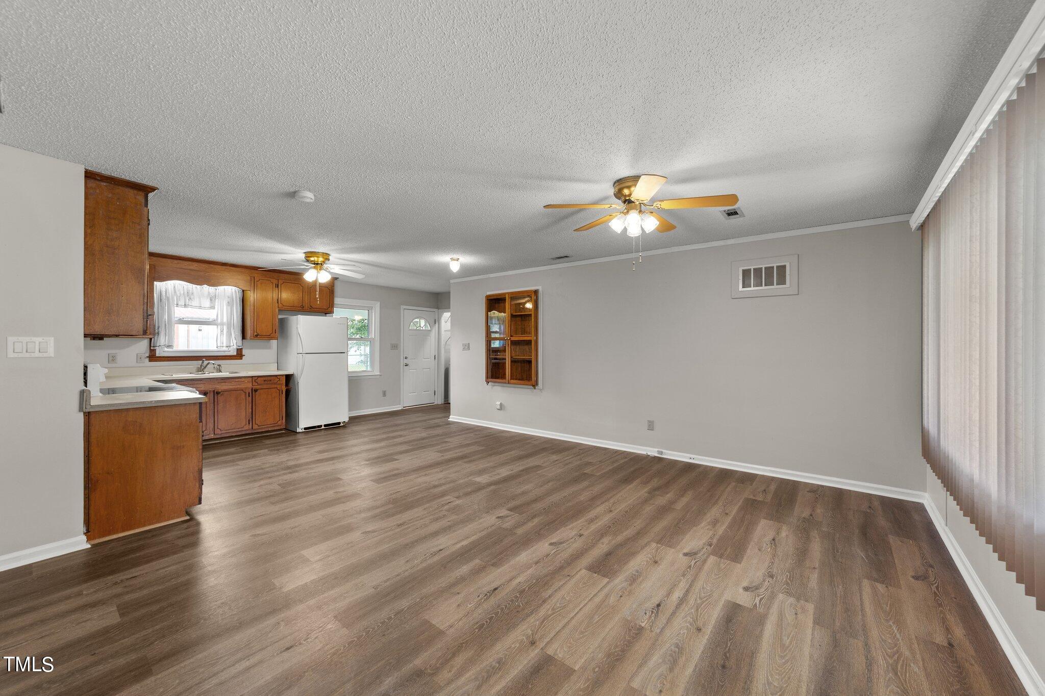 4868 Buffalo Road Selma, NC 27576 - Photo 7 of 48 wooden floor in an empty room with a window